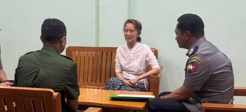 Aung San Suu Kyi (centre) talks to officials in an undisclosed location in Myanmar. Photo: Myanmar Military True News Information Team via AP