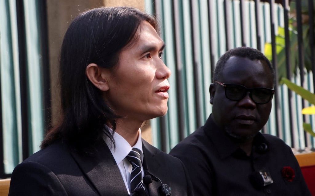 South Sudan foreign ministry spokesman Agok Anyar looks on as Vietnamese deportee Tuan Phan speaks during a press conference at Juba International Airport on Friday. Photo: Reuters South Sudan foreign ministry spokesman Agok Anyar looks on as Vietnamese deportee Tuan Phan speaks during a press conference at Juba International Airport on Friday. Photo: Reuters