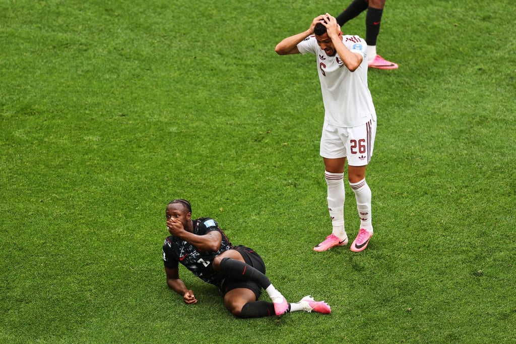 Qatar’s Mohamed Manai (right) reacts after his challenge left Canada’s Ismael Kone badly injured. Photo: AP Qatar’s Mohamed Manai (right) reacts after his challenge left Canada’s Ismael Kone badly injured. Photo: AP