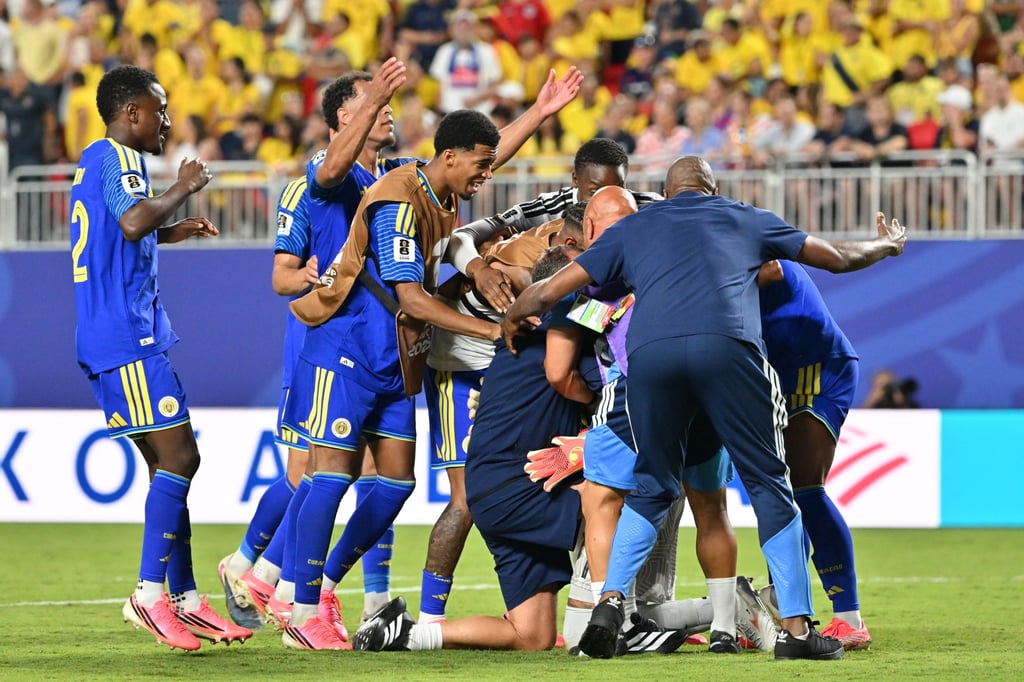 Goalkeeper Eloy Room was mobbed by teammates and staff at the end of the game. Photo: EPA Goalkeeper Eloy Room was mobbed by teammates and staff at the end of the game. Photo: EPA