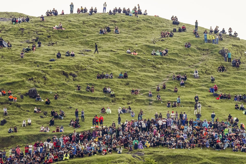 Spectators watch the 2022 MotoGP on a hill near the Mandalika circuit. Photo: Getty Images Spectators watch the 2022 MotoGP on a hill near the Mandalika circuit. Photo: Getty Images