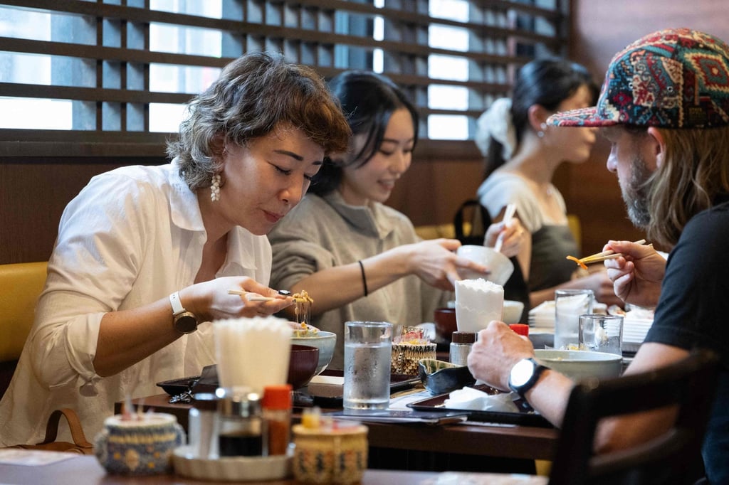 US tourist Wesley Smith (right) and his wife Maya Bourdeau eat natto at the Natto Kobo Sendai-ya restaurant in Tokyo. Photo: AFP US tourist Wesley Smith (right) and his wife Maya Bourdeau eat natto at the Natto Kobo Sendai-ya restaurant in Tokyo. Photo: AFP