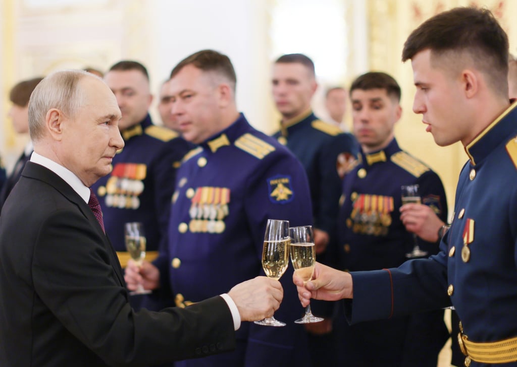 Russian President Vladimir Putin holds up a glass for a toast on Tuesday as he meets graduates of higher education institutions from various ministries. Photo: EPA via Kremlin Pool/Sputnik Russian President Vladimir Putin holds up a glass for a toast on Tuesday as he meets graduates of higher education institutions from various ministries. Photo: EPA via Kremlin Pool/Sputnik