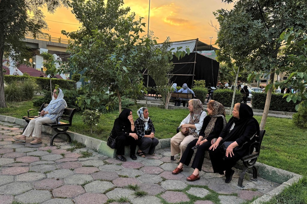 Iranians chat in a park in Tehran on Tuesday. The government must submit a report to the IAEA detailing whether any nuclear material was lost or damaged in US-Israeli strikes. Photo: AFP Iranians chat in a park in Tehran on Tuesday. The government must submit a report to the IAEA detailing whether any nuclear material was lost or damaged in US-Israeli strikes. Photo: AFP