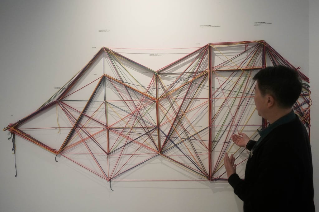 Out Museum founder Xiangqi Chen admires “Collective Notation”, an interactive installation displayed at the museum on June 22, 2026. Photo: AP