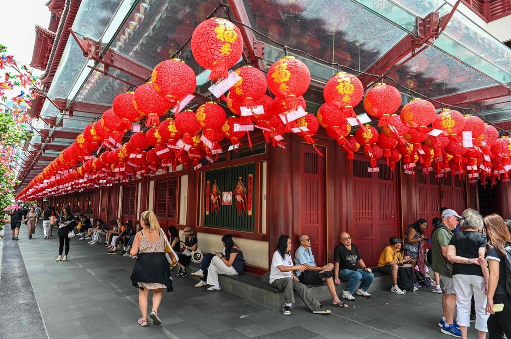 People rest outside the Buddha Tooth Relic Temple in Singapore’s Chinatown on February 12, 2026. Are Singaporeans of Chinese heritage “Singapore Chinese” or “Chinese Singaporean”? The debate reveals elements of cross-linguistic influence over the centuries. Photo: AFP