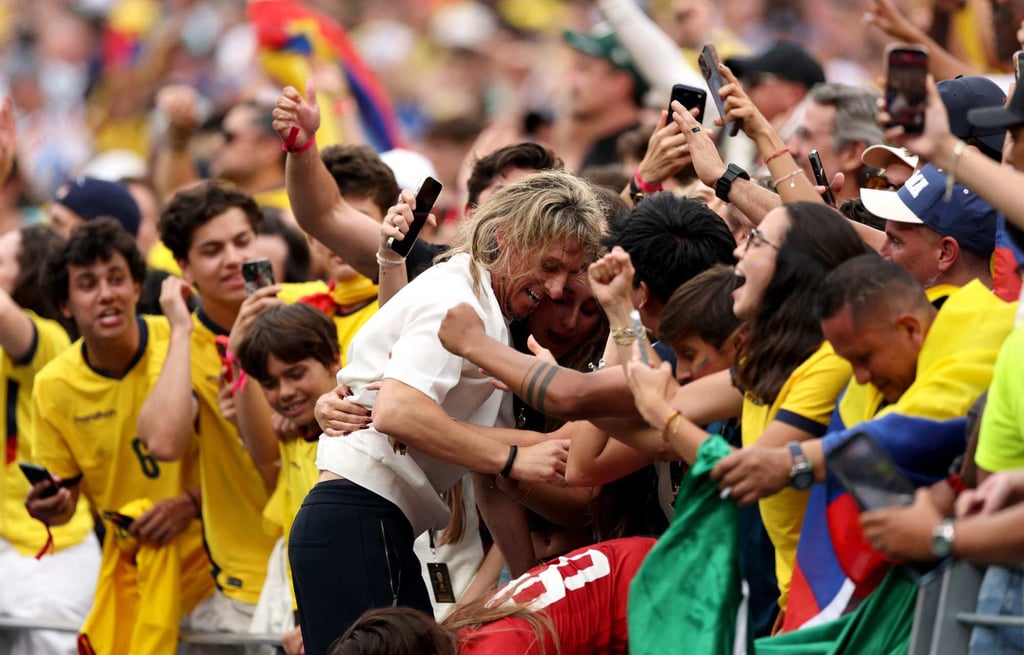 Ecuador boss Sebastian Beccacece celebrates with fans after climbing into the stands. Photo: Getty Images