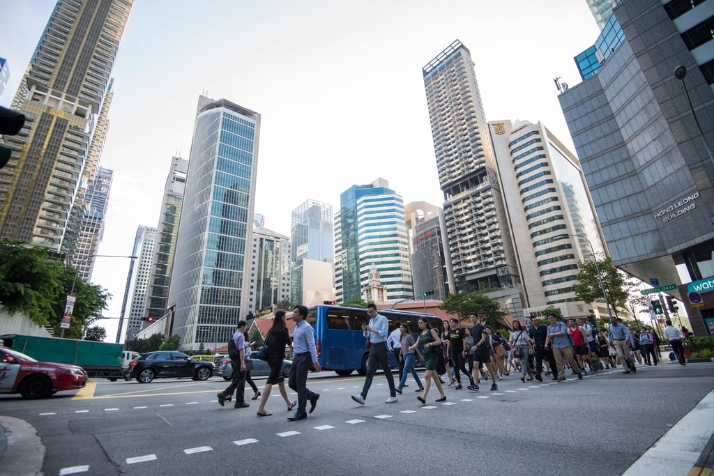 Commuters walk along a street in Singapore’s Central Business District. Photo: Shutterstock Commuters walk along a street in Singapore’s Central Business District. Photo: Shutterstock