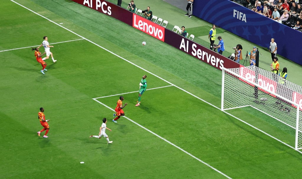 Uzbekistan’s Eldor Shomurodov lobs goalkeeper Lionel Mpasi to give his side the lead. Photo: Reuters