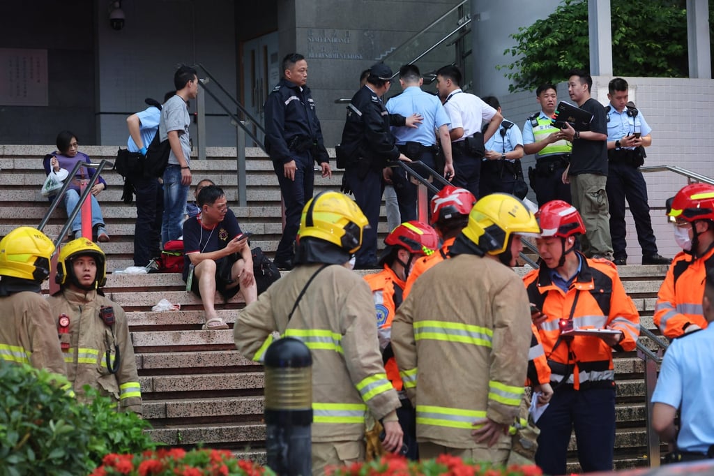 Some of those injured in the accident wait on the steps for help. Photo: Edmond So