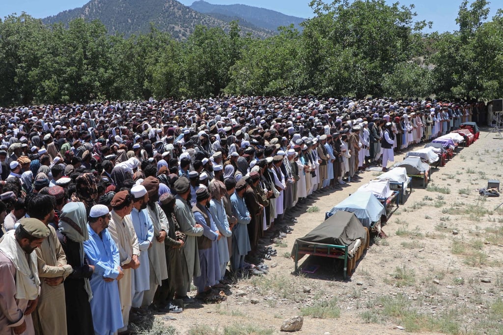 Afghans offer funeral prayers for the victims of Pakistani airstrikes in a village in Paktia province on Monday. Photo: AFP