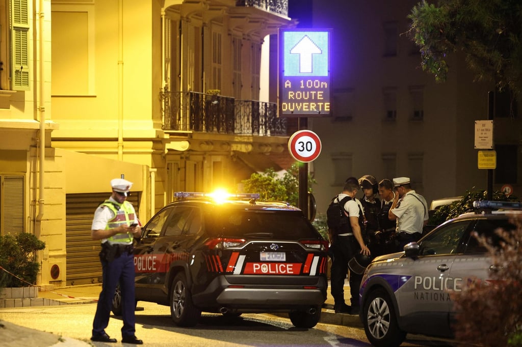 Monacan and French police officers stand near the area of an explosion in Monaco on Monday. Photo: AFP