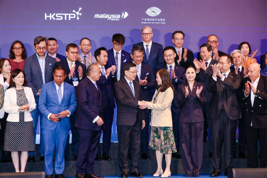 City leader John Lee shakes hands with SCMP publisher Tammy Tam at the GBA-Asean Summit, which brought together government officials, business leaders and institutional investors. Photo: Handout.