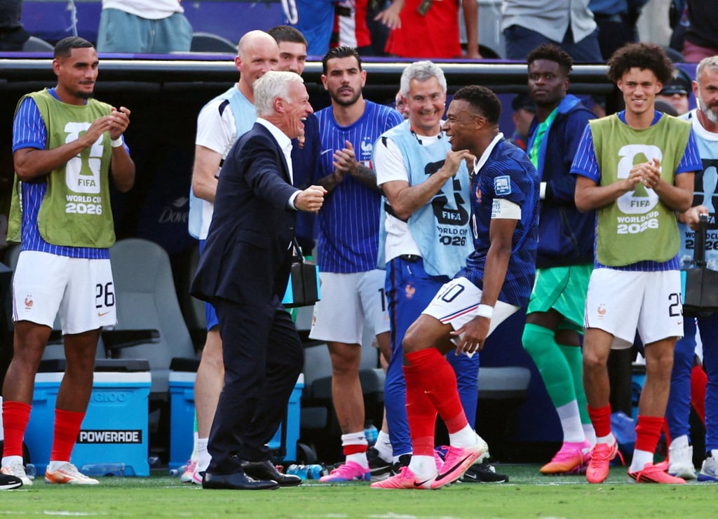 Kylian Mbappe celebrates scoring France’s first goal with coach Didier Deschamps. Photo: Reuters Kylian Mbappe celebrates scoring France’s first goal with coach Didier Deschamps. Photo: Reuters