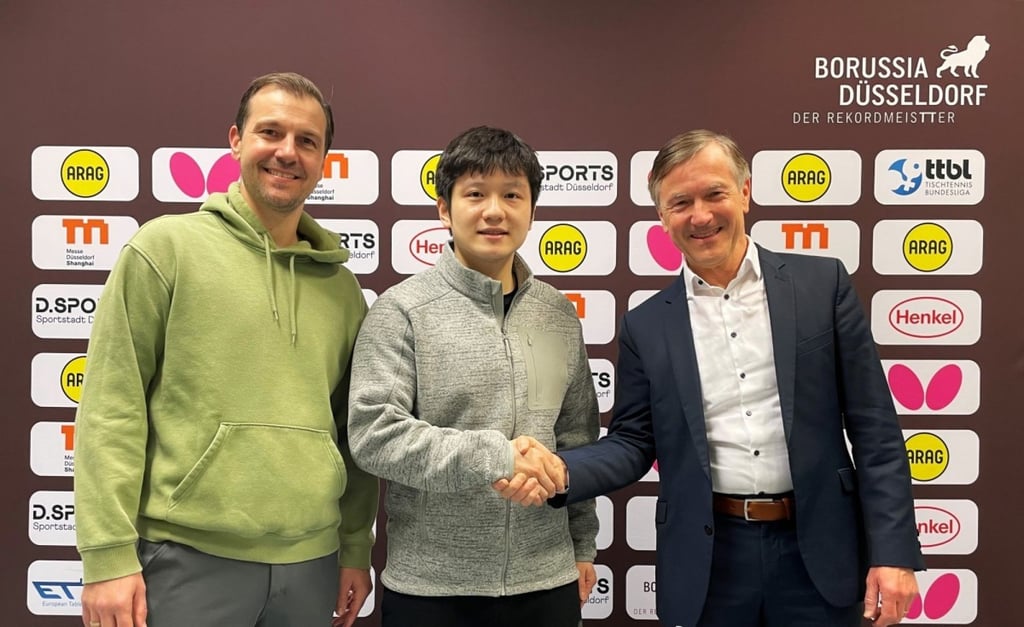 Fan Zhendong (middle) with Borussia manager Andreas Preuss (right) and German legend Timo Boll. Photo: Handout Fan Zhendong (middle) with Borussia manager Andreas Preuss (right) and German legend Timo Boll. Photo: Handout