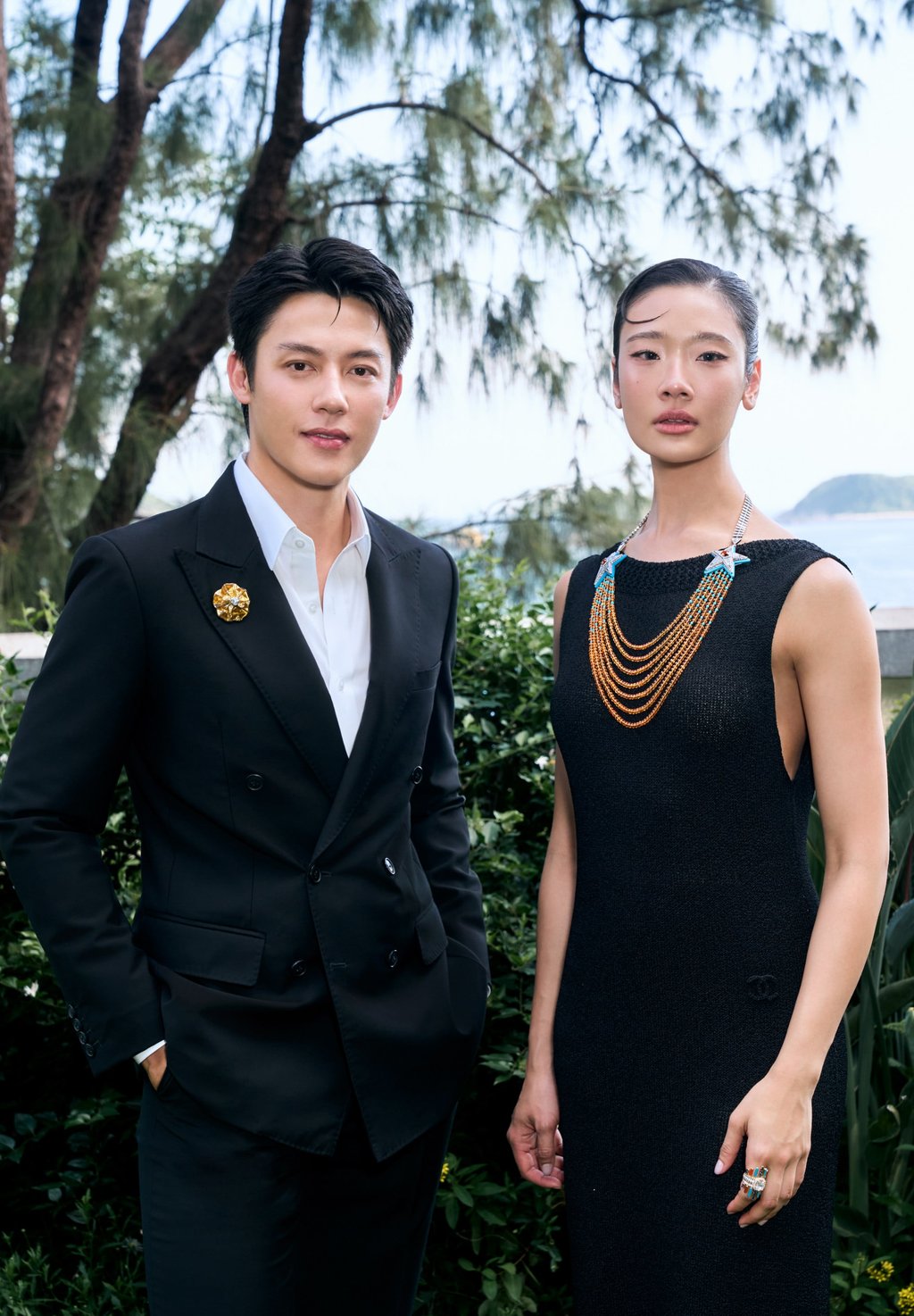 Mark Prin Suparat wears the Chanel Symbole Camélia Solaire brooch while Chutimon “Aokbab” Chuengcharoensukying wears the Chanel Symbole Ombré necklace. Photo: Handout Mark Prin Suparat wears the Chanel Symbole Camélia Solaire brooch while Chutimon “Aokbab” Chuengcharoensukying wears the Chanel Symbole Ombré necklace. Photo: Handout