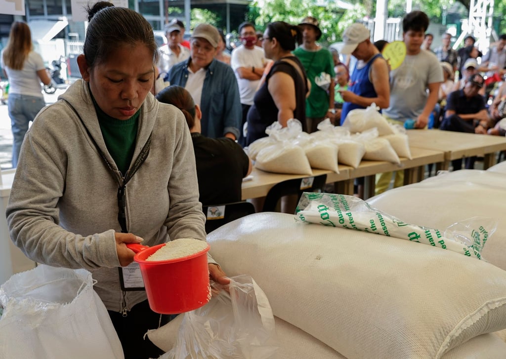 A government worker prepares bags of subsidised rice to be sold market in Quezon City, Metro Manila, last year. Photo: EPA-EFE A government worker prepares bags of subsidised rice to be sold market in Quezon City, Metro Manila, last year. Photo: EPA-EFE
