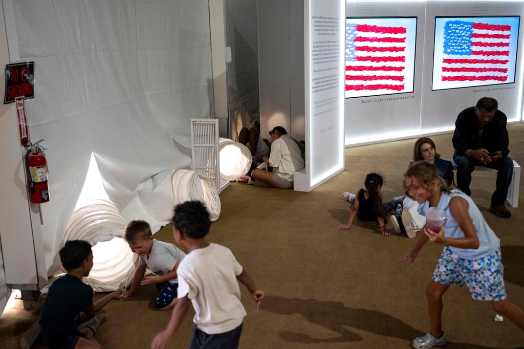People sit in front of vents pumping cool air into a tent as they visit the Great American State Fair on the National Mall in Washington on Thursday, ahead of the coming July 4 holiday. Photo: AFP People sit in front of vents pumping cool air into a tent as they visit the Great American State Fair on the National Mall in Washington on Thursday, ahead of the coming July 4 holiday. Photo: AFP