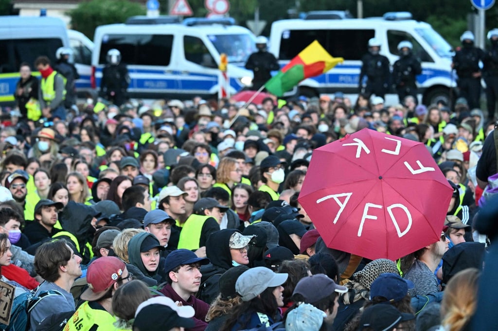 A participant holds up an umbrella with the lettering “F*** AfD” as people gather for a sit-in to block the access road at Gothaer Platz to the Messe Erfurt fairground in Erfurt, eastern Germany, on Saturday. Photo: AFP A participant holds up an umbrella with the lettering “F*** AfD” as people gather for a sit-in to block the access road at Gothaer Platz to the Messe Erfurt fairground in Erfurt, eastern Germany, on Saturday. Photo: AFP