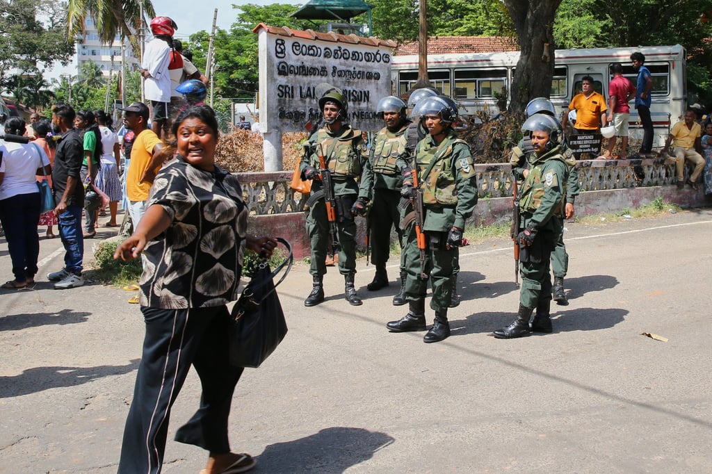 Security personnel stand guard outside Negombo prison where deadly clashes broke out on Sunday. Photo: AP Security personnel stand guard outside Negombo prison where deadly clashes broke out on Sunday. Photo: AP