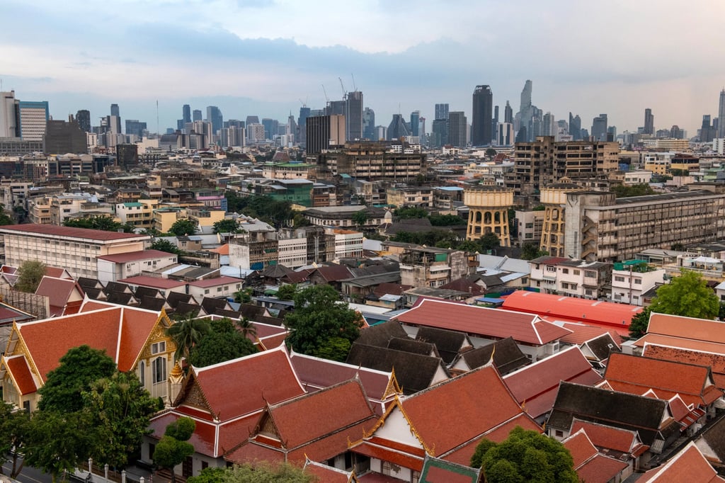 The Bangkok skyline: modern high-rises behind the red-tiled temple roofs of Wat Saket. Photo: AFP The Bangkok skyline: modern high-rises behind the red-tiled temple roofs of Wat Saket. Photo: AFP