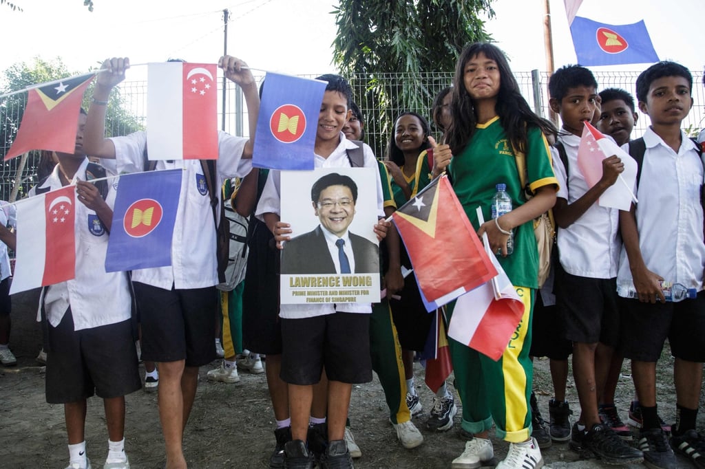 Children wait for Singapore’s Prime Minister Laurence Wong along a road in Dili on Thursday. Photo: AFP Children wait for Singapore’s Prime Minister Laurence Wong along a road in Dili on Thursday. Photo: AFP