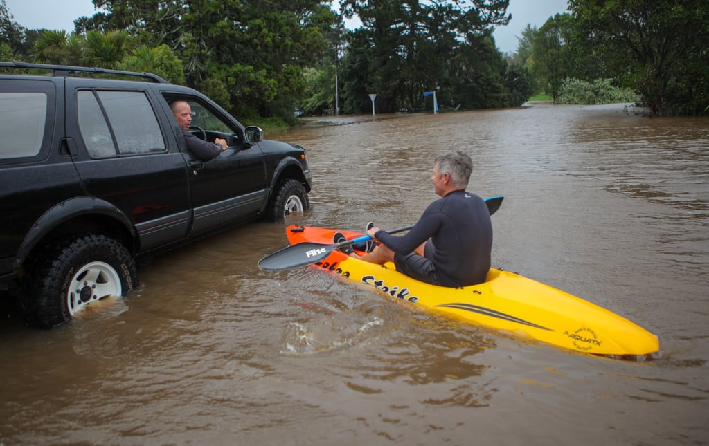 A man kayaks across a flooded street in Auckland, New Zealand, on February 14, 2023. Photo: Xinhua A man kayaks across a flooded street in Auckland, New Zealand, on February 14, 2023. Photo: Xinhua