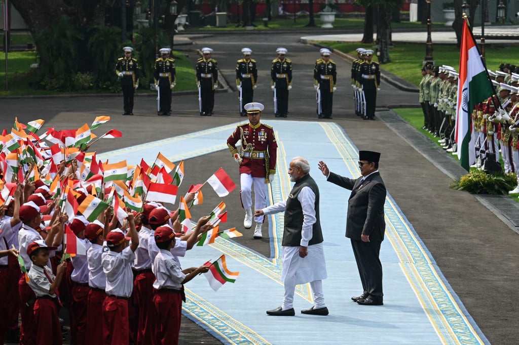 India’s Prime Minister Narendra Modi (left) and Indonesia’s President Prabowo Subianto meet children after inspecting a guard of honour during a welcome ceremony at the Merdeka Palace in Jakarta on Tuesday. Photo: AFP India’s Prime Minister Narendra Modi (left) and Indonesia’s President Prabowo Subianto meet children after inspecting a guard of honour during a welcome ceremony at the Merdeka Palace in Jakarta on Tuesday. Photo: AFP