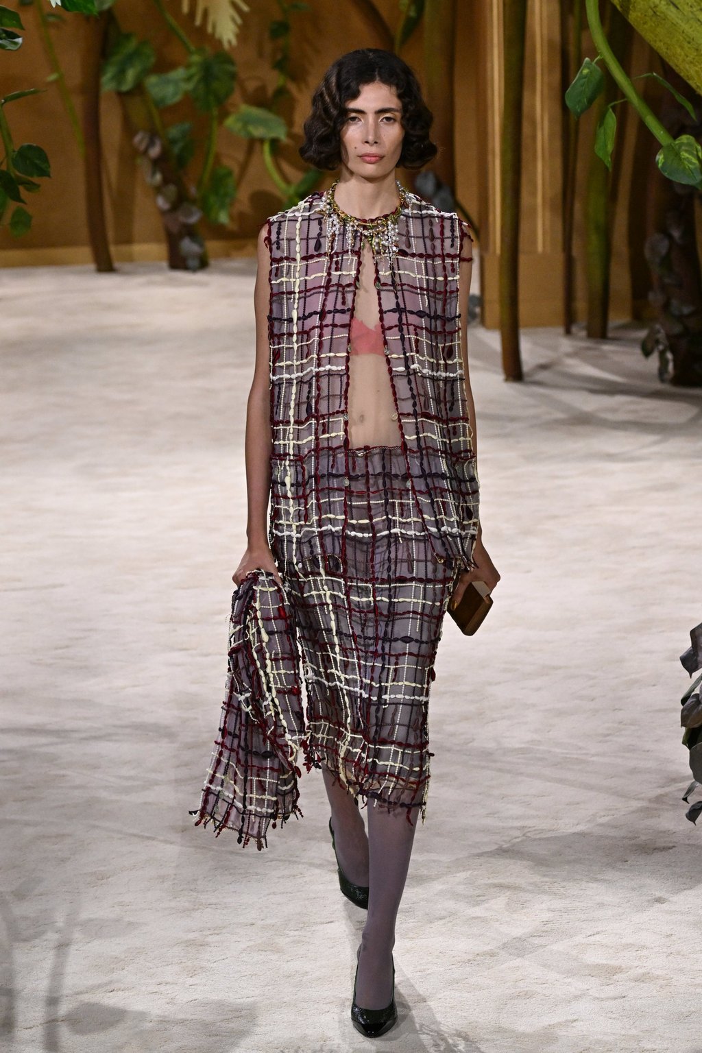 Chanel’s opening look was a new take on the maison’s classic tweed suit. Photo: AP Chanel’s opening look was a new take on the maison’s classic tweed suit. Photo: AP