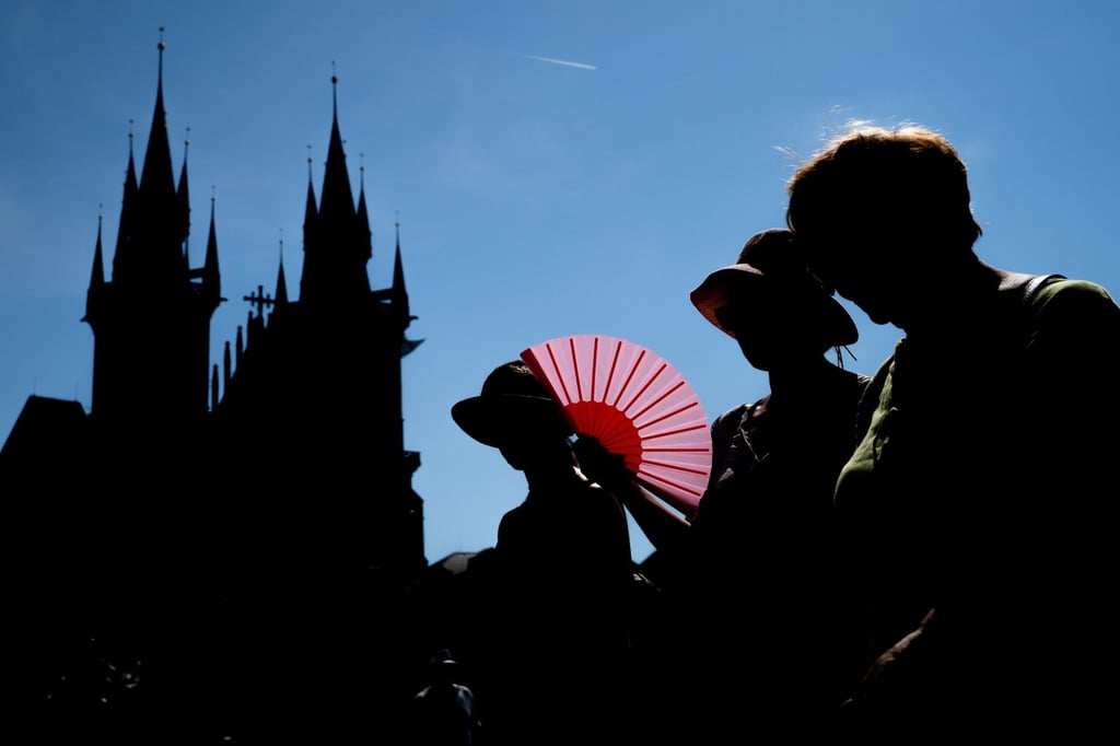 Tourists use a folding fan in Prague, in the Czech Republic, on an unusually hot day in June 2026. Photo: EPA