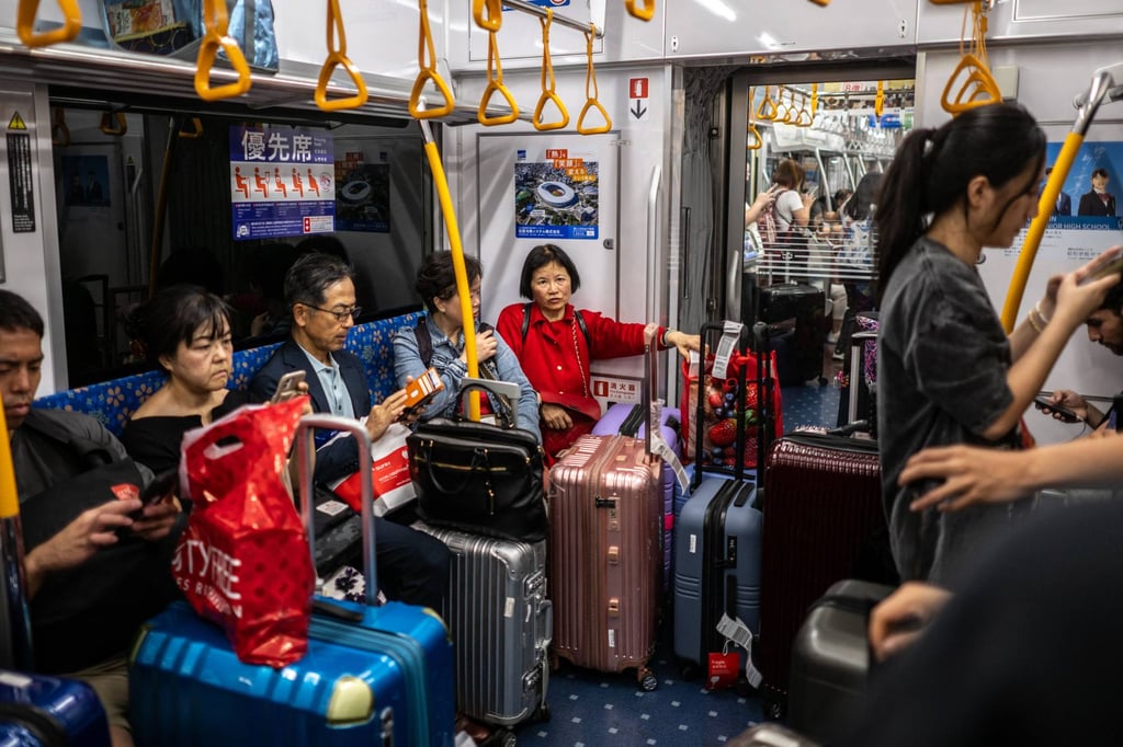 Tourists travel on a subway train to Tokyo’s city centre from Narita International Airport. Photo: AFP Tourists travel on a subway train to Tokyo’s city centre from Narita International Airport. Photo: AFP