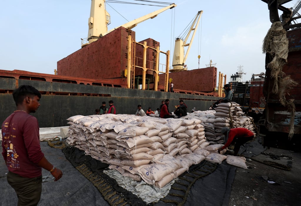 A worker arranges sugar bags in a net to load them onto a cargo ship at the Deendayal Port in Kandla, India’s Gujarat state, in September 2024. Photo: Reuters A worker arranges sugar bags in a net to load them onto a cargo ship at the Deendayal Port in Kandla, India’s Gujarat state, in September 2024. Photo: Reuters