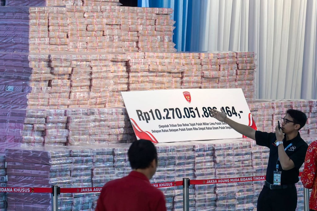 Officials from the Attorney General’s Office prepare a pile of Indonesian banknotes totalling around US$587 million – recovered from various corruption cases and environmental fines – before a ceremony for its handover to the government on May 13. Photo: AFP Officials from the Attorney General’s Office prepare a pile of Indonesian banknotes totalling around US$587 million – recovered from various corruption cases and environmental fines – before a ceremony for its handover to the government on May 13. Photo: AFP