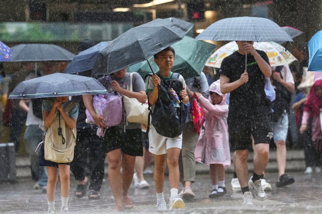 Residents brave heavy rain in Wan Chai. Photo: Karma Lo Residents brave heavy rain in Wan Chai. Photo: Karma Lo