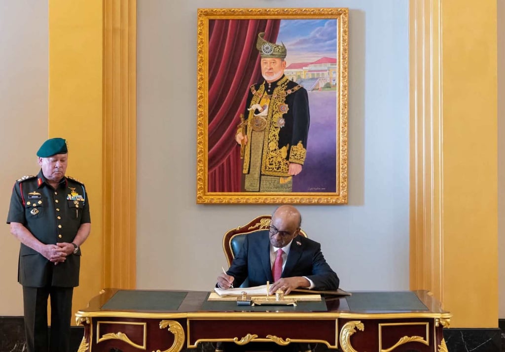 Singapore President Tharman Shanmugaratnam signs the guest book as Malaysian King Sultan Ibrahim Iskandar looks on. Photo: Facebook/officialsultanibrahim Singapore President Tharman Shanmugaratnam signs the guest book as Malaysian King Sultan Ibrahim Iskandar looks on. Photo: Facebook/officialsultanibrahim