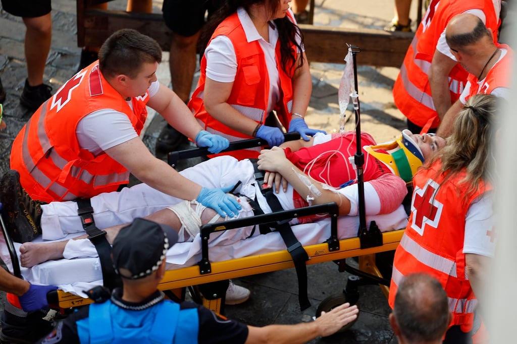 Medical services transport an athlete after he was shot during the final race of the San Fermin festival in Pamplona on Tuesday. Photo: EPA Medical services transport an athlete after he was shot during the final race of the San Fermin festival in Pamplona on Tuesday. Photo: EPA