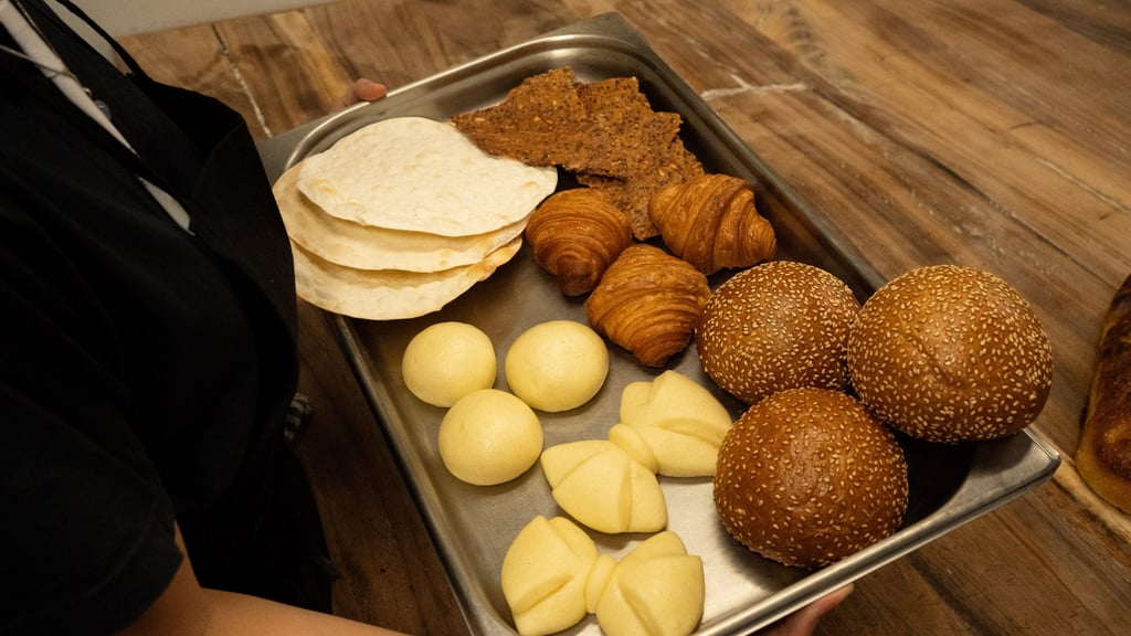 Alexandra holds a tray of her baked goods, including steamed mantou bow ties. Photo: Food Matters Group Alexandra holds a tray of her baked goods, including steamed mantou bow ties. Photo: Food Matters Group