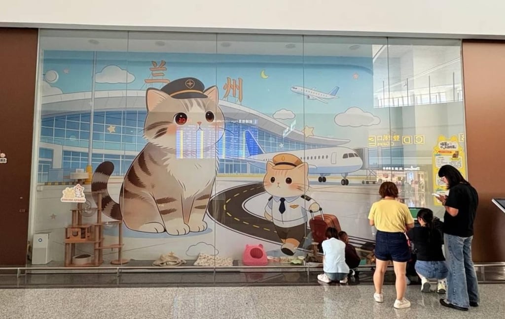 Even through the glass barrier, delighted passengers love pausing to interact and play with the adorable cats. Photo: Handout Even through the glass barrier, delighted passengers love pausing to interact and play with the adorable cats. Photo: Handout