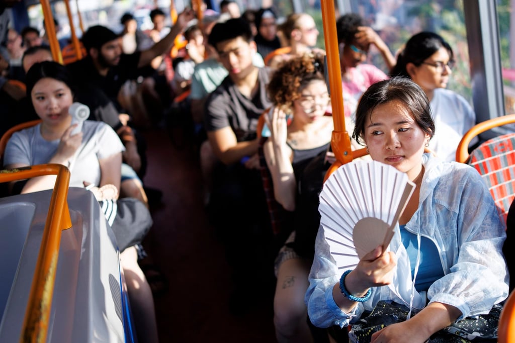 Passengers use fans to cool down on a TfL bus during a heatwave in East London on June 24. Photo: EPA Passengers use fans to cool down on a TfL bus during a heatwave in East London on June 24. Photo: EPA