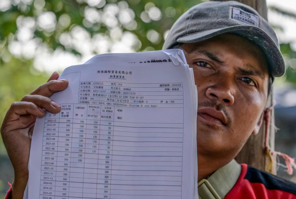 Akhmad, a former crew member of a Chinese fishing vessel, holds up his contract document indicating his monthly wages. Photo: AFP Akhmad, a former crew member of a Chinese fishing vessel, holds up his contract document indicating his monthly wages. Photo: AFP