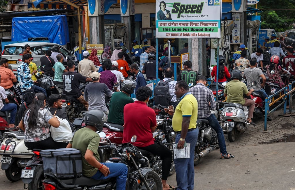 Motorcyclists queue at a petrol station in Mumbai on July 9. Photo: EPA Motorcyclists queue at a petrol station in Mumbai on July 9. Photo: EPA