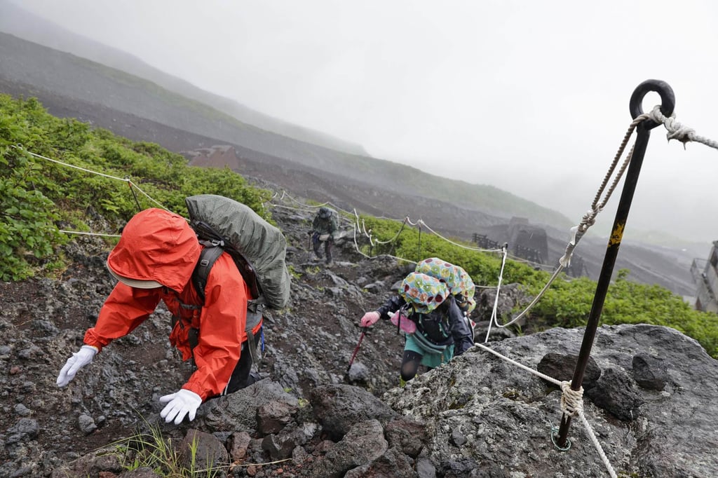 Hikers make their way up Mount Fuji in 2024 as the summer climbing season was about to begin. Photo: Kyodo Hikers make their way up Mount Fuji in 2024 as the summer climbing season was about to begin. Photo: Kyodo