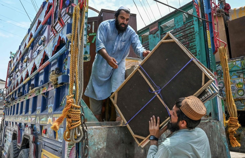 Men load their belongings onto a truck in Peshawar on Monday as they prepare to depart for Afghanistan. Photo: AFP Men load their belongings onto a truck in Peshawar on Monday as they prepare to depart for Afghanistan. Photo: AFP
