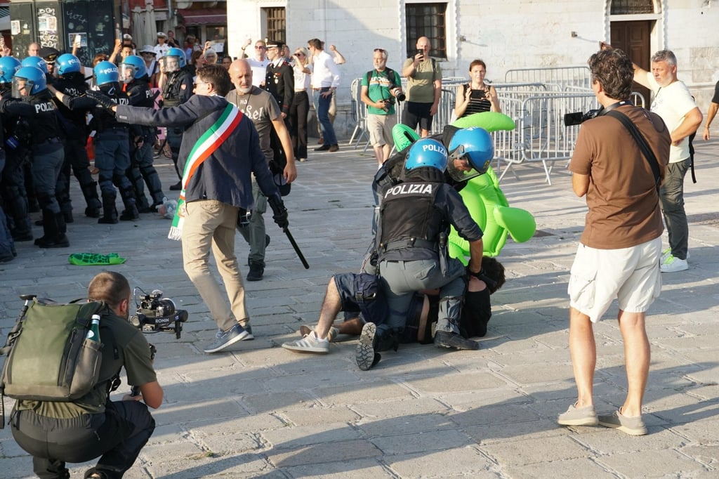 A person is detained by police during a protest against a visit by US Ambassador to Italy Tilman Fertitta in Venice on Friday. Photo: EPA A person is detained by police during a protest against a visit by US Ambassador to Italy Tilman Fertitta in Venice on Friday. Photo: EPA