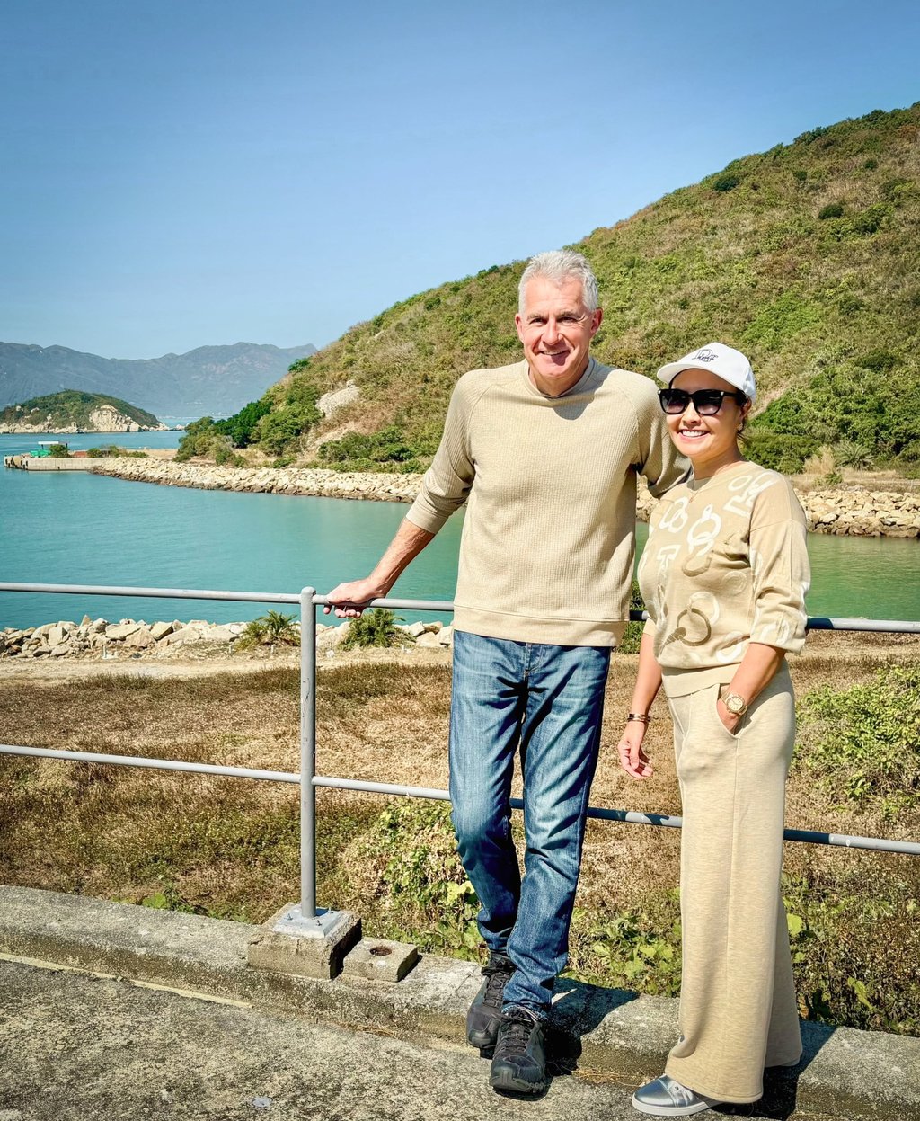 Katie Aung (right) and Les Bird at Tai A Chau during Katie’s return visit. They are standing where ramshackle boats full of desperate refugees arrived 35 years earlier. Photo: courtesy Les Bird Katie Aung (right) and Les Bird at Tai A Chau during Katie’s return visit. They are standing where ramshackle boats full of desperate refugees arrived 35 years earlier. Photo: courtesy Les Bird