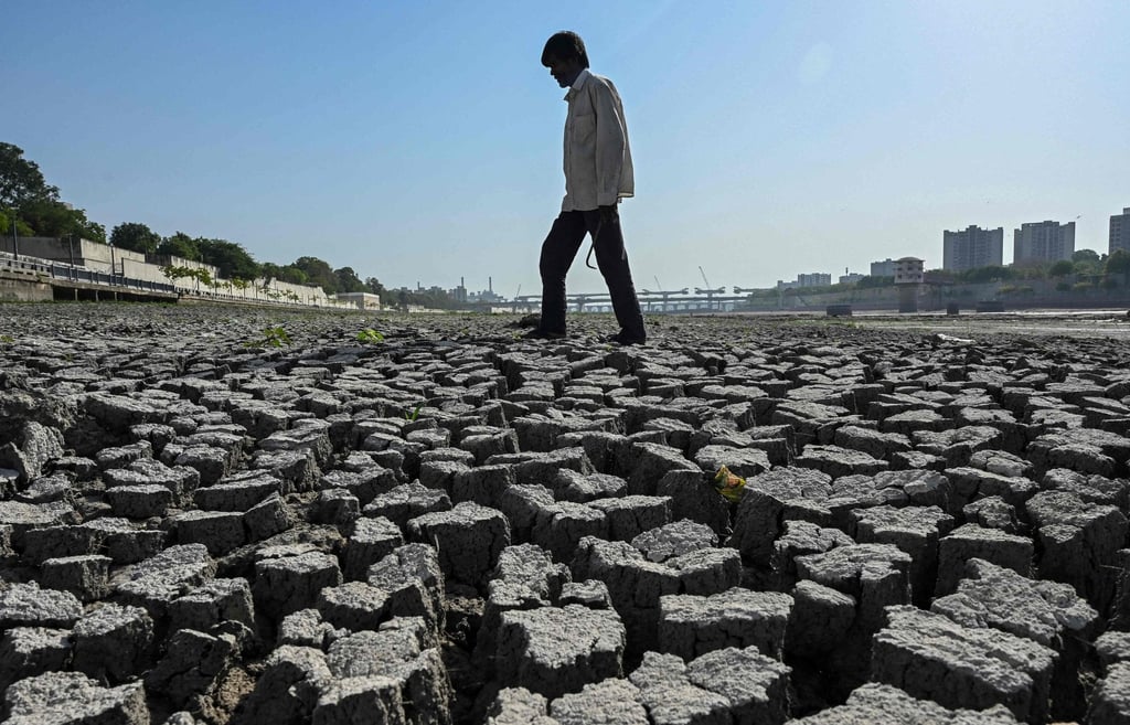 A man walks on the dry riverbed of the Sabarmati River in Ahmedabad on May 8. Photo: AFP A man walks on the dry riverbed of the Sabarmati River in Ahmedabad on May 8. Photo: AFP
