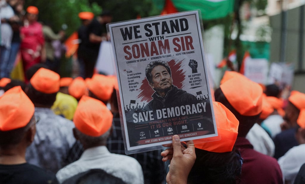 A CJP supporter holds a poster of Sonam Wangchuk on Sunday after authorities move him to a hospital during his hunger strike. Photo: Reuters A CJP supporter holds a poster of Sonam Wangchuk on Sunday after authorities move him to a hospital during his hunger strike. Photo: Reuters