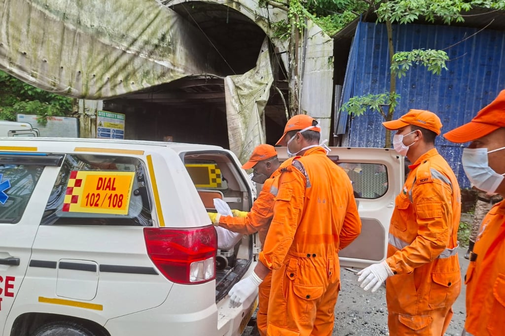 Rescue workers carry the body of a victim into an ambulance outside the entrance to the a hydropower project tunnel in Gangtok, India, on Tuesday. Photo: AP Rescue workers carry the body of a victim into an ambulance outside the entrance to the a hydropower project tunnel in Gangtok, India, on Tuesday. Photo: AP