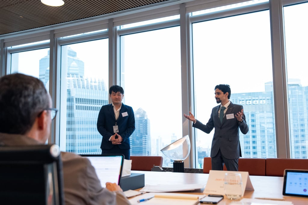 Omar Ahmed Mohamed Ismail (right), co-founder and chief technology officer of HydroForge, explains his clean energy company’s business plans to jury members. Omar Ahmed Mohamed Ismail (right), co-founder and chief technology officer of HydroForge, explains his clean energy company’s business plans to jury members.