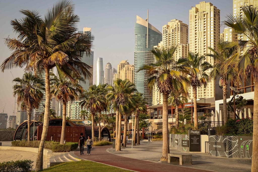 People walk through a beach residence district of UAE financial hub Dubai on Tuesday. Luhut was sceptical of the notion that Indonesia couldn’t compete with established financial hubs. Photo: AFP